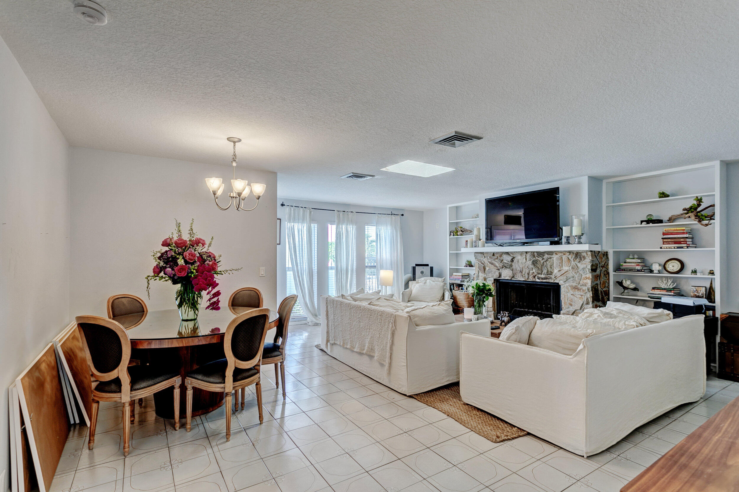 430 Mars Way Juno Beach, FL 33408 - Photo 15 of 65 a living room with furniture a fireplace and a dining table with wooden floor
