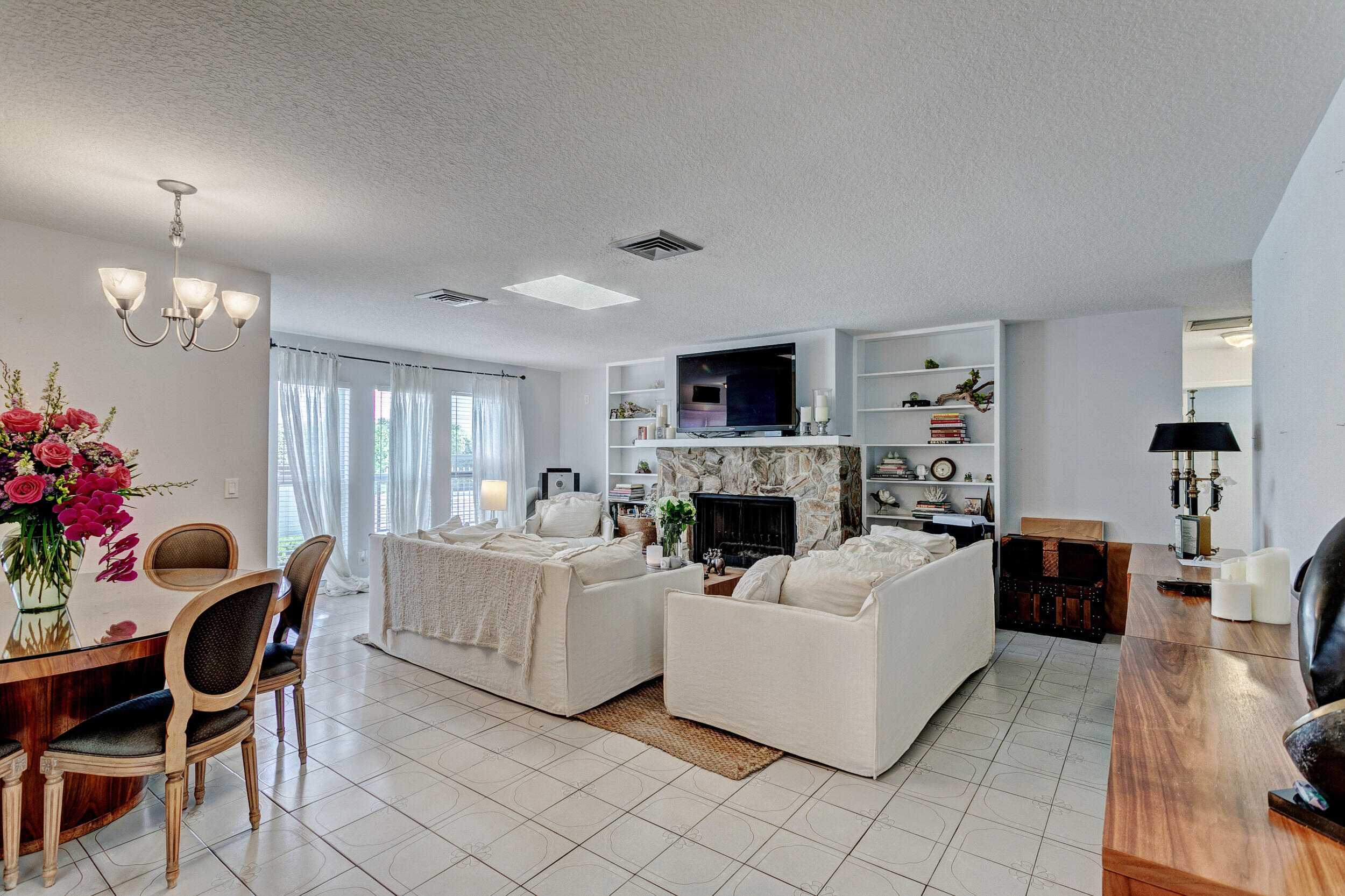 430 Mars Way Juno Beach, FL 33408 - Photo 16 of 65 a living room with furniture a fireplace and a potted plant
