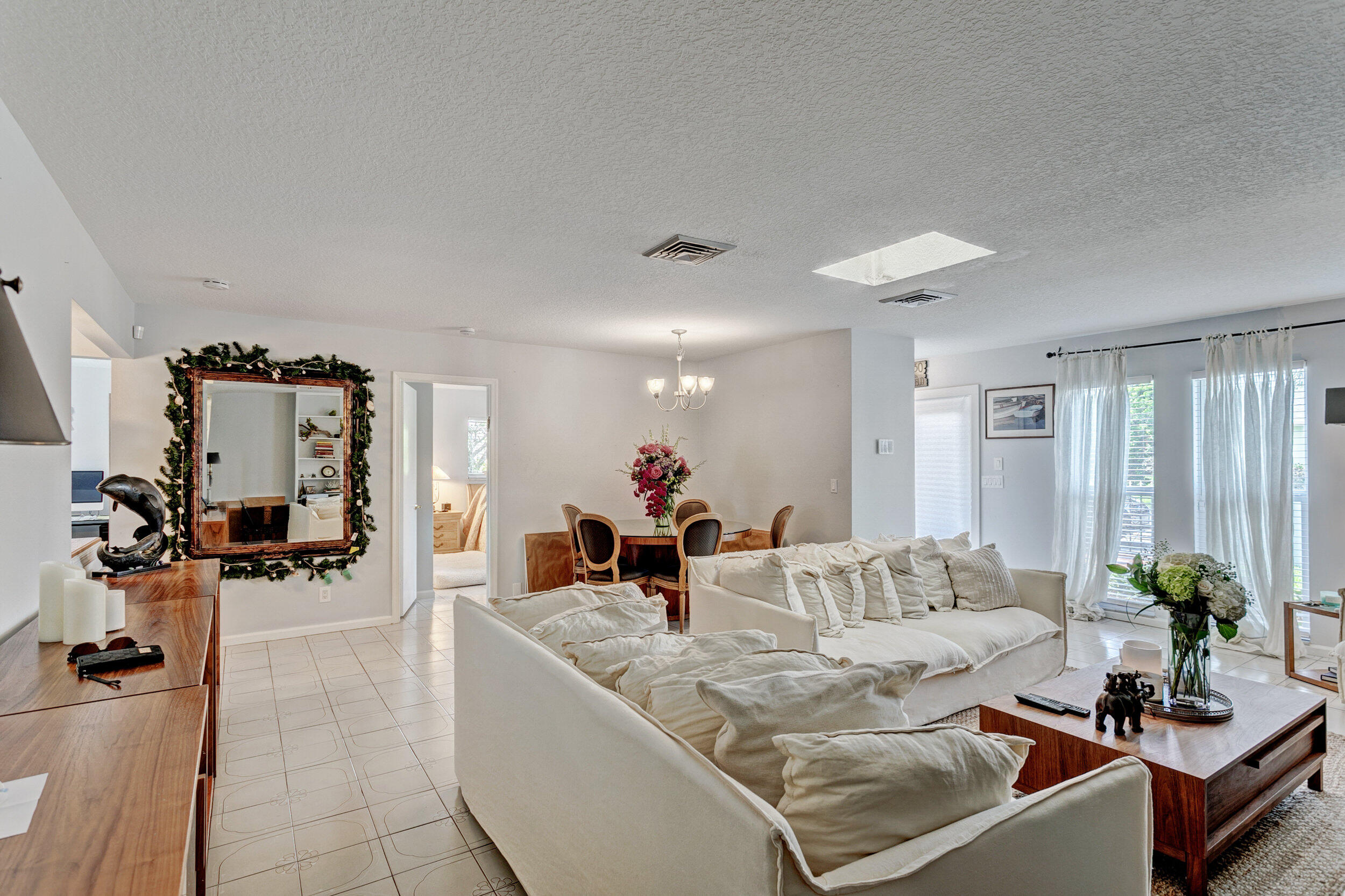 430 Mars Way Juno Beach, FL 33408 - Photo 19 of 65 a living room with furniture and a large mirror