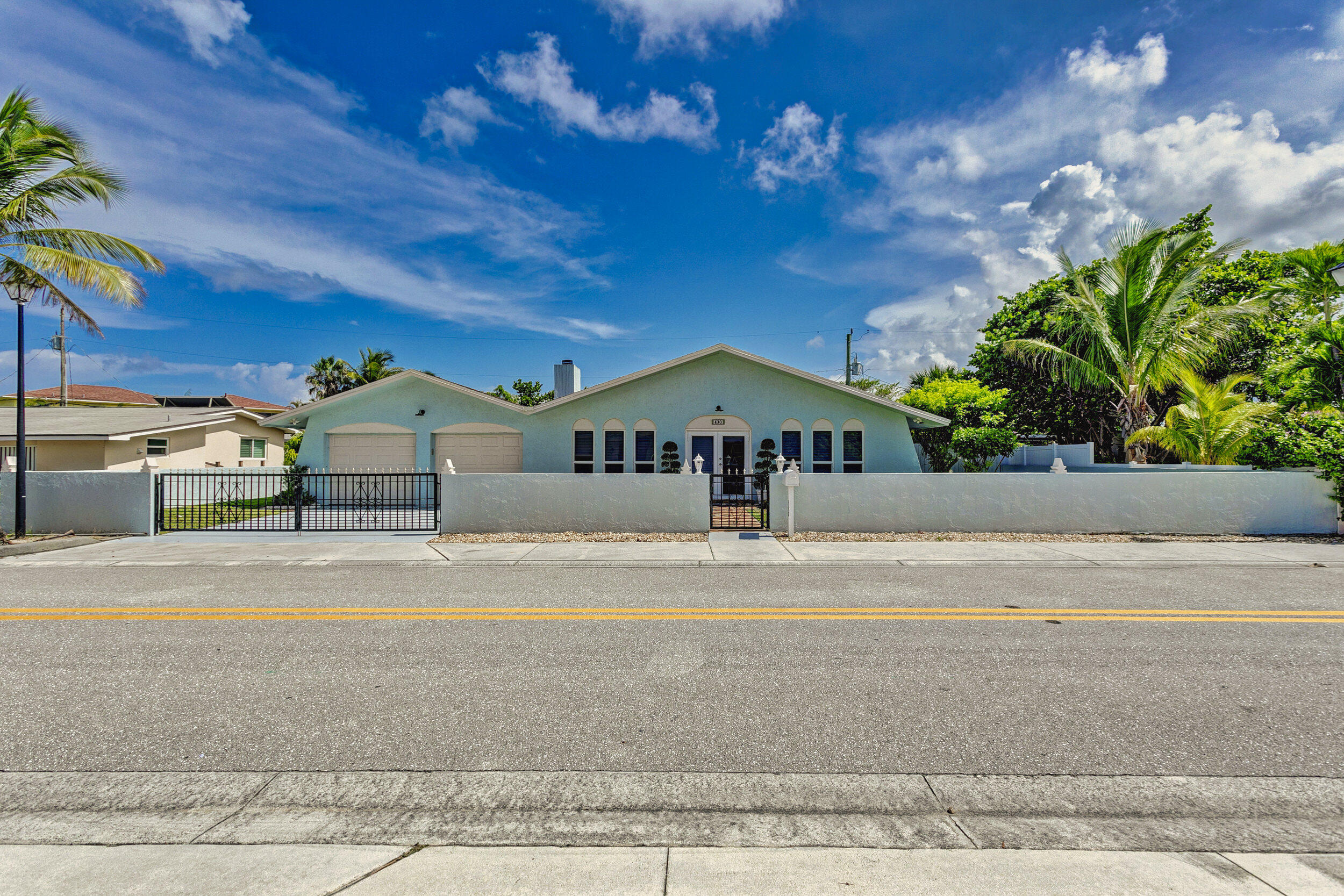 430 Mars Way Juno Beach, FL 33408 - Photo 2 of 65 a front view of a house with a yard