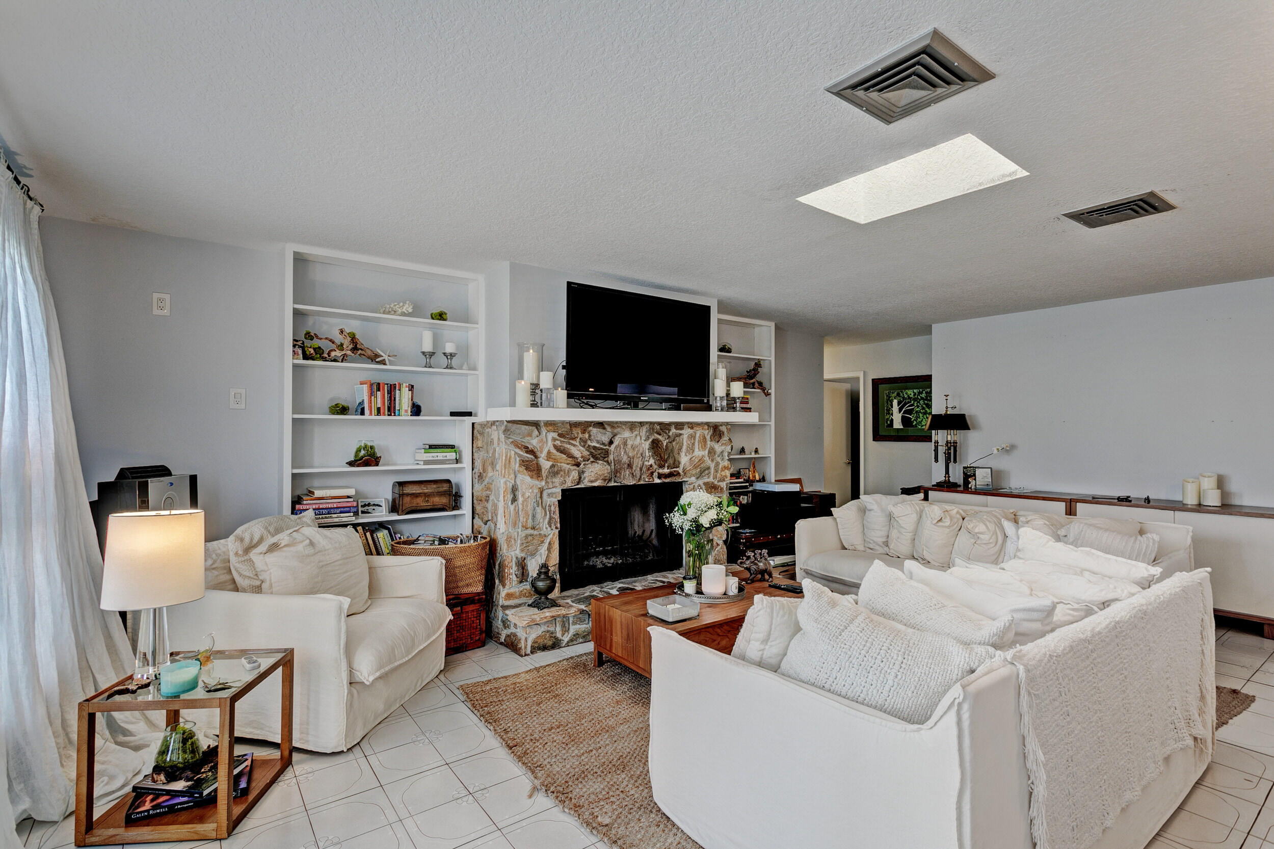 430 Mars Way Juno Beach, FL 33408 - Photo 21 of 65 a living room with furniture a fireplace and a flat screen tv
