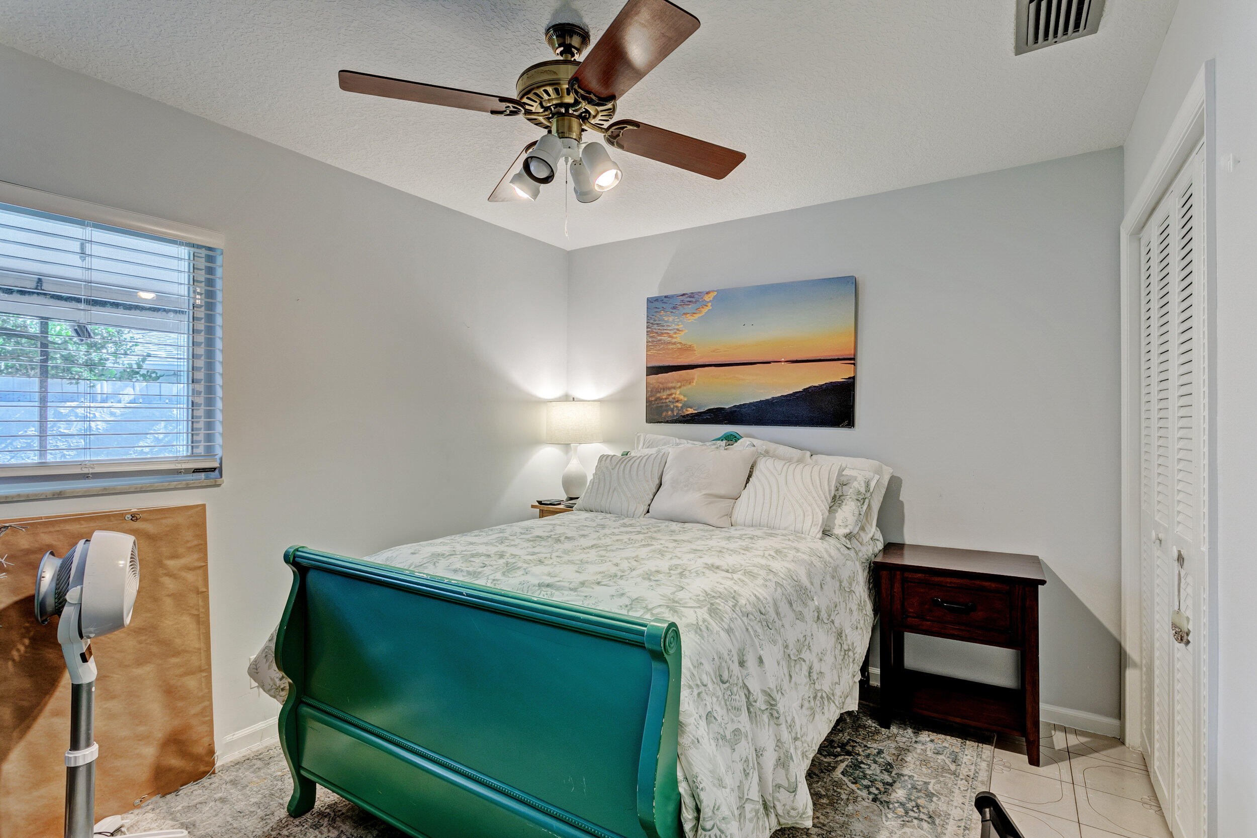 430 Mars Way Juno Beach, FL 33408 - Photo 27 of 65 a bedroom with a bed a rug and a window