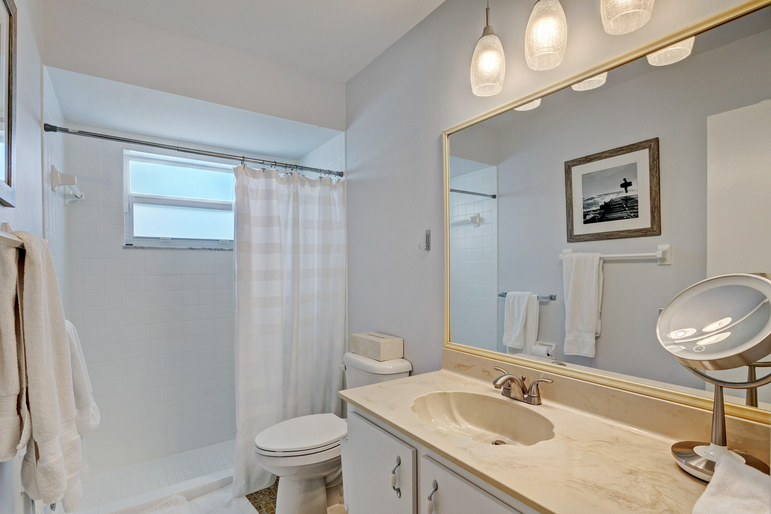 430 Mars Way Juno Beach, FL 33408 - Photo 29 of 65 a bathroom with a sink a toilet a mirror and shower