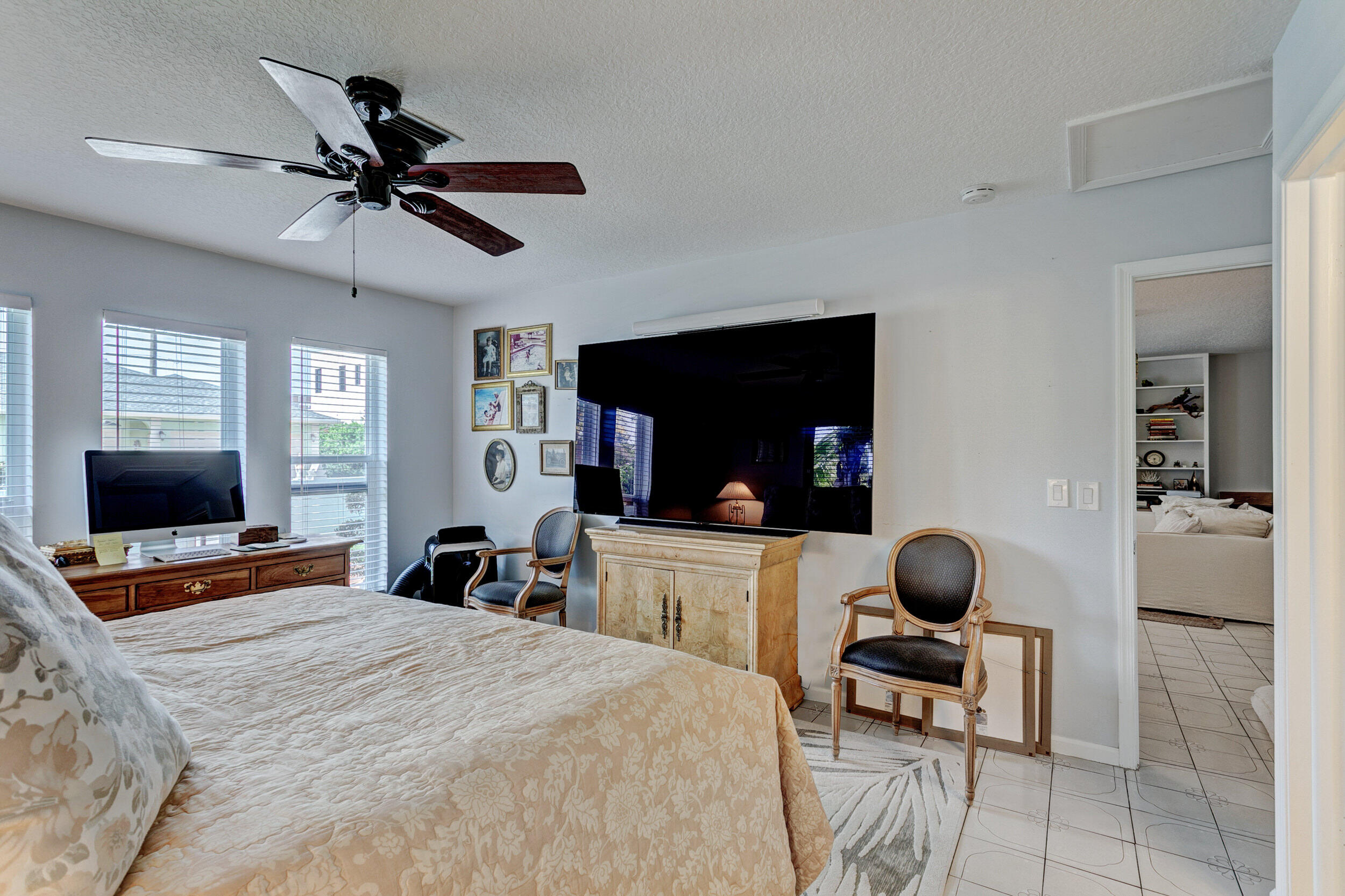 430 Mars Way Juno Beach, FL 33408 - Photo 33 of 65 a bedroom with a bed and a flat screen tv