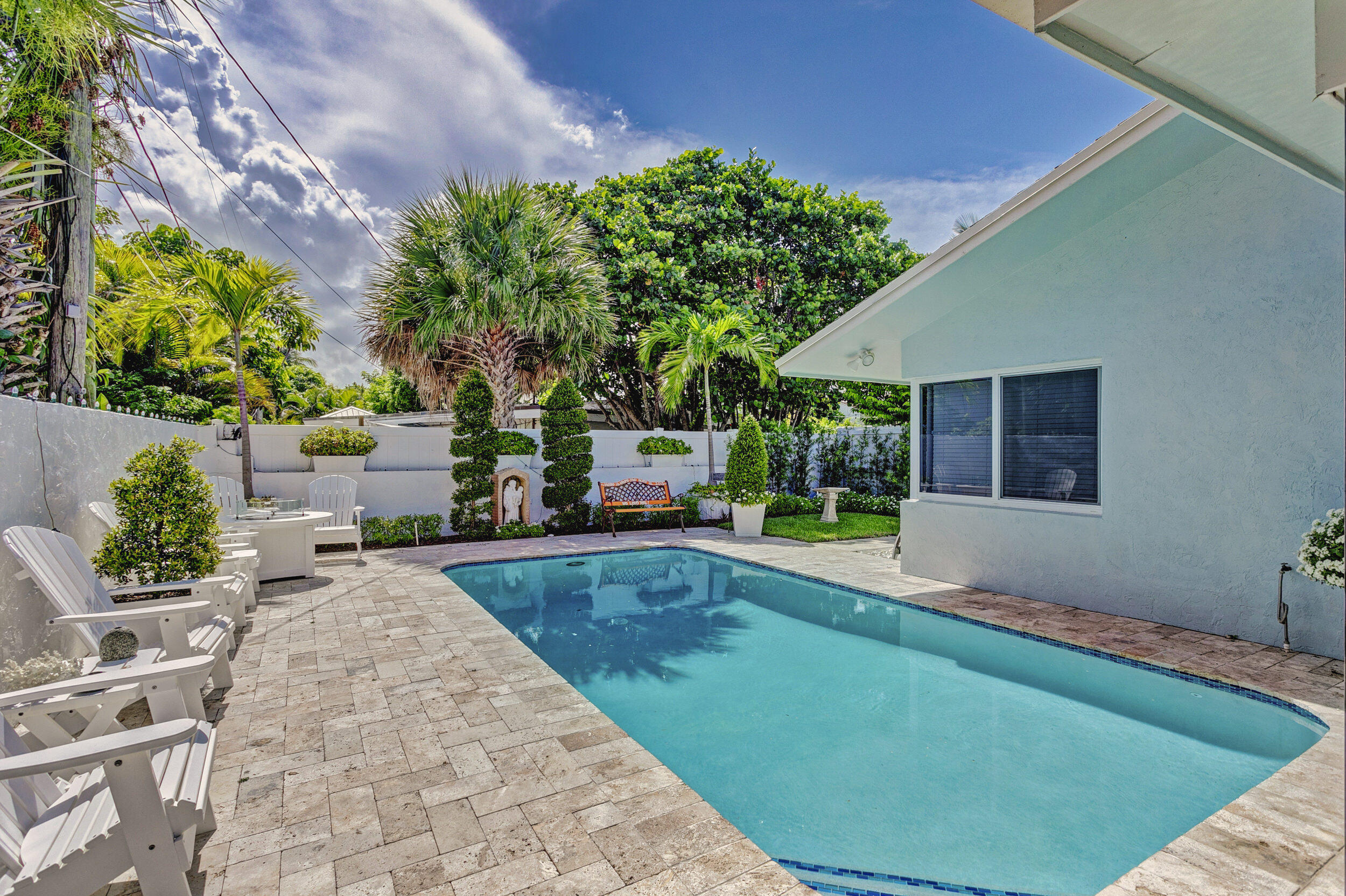 430 Mars Way Juno Beach, FL 33408 - Photo 45 of 65 a swimming pool with outdoor seating and yard