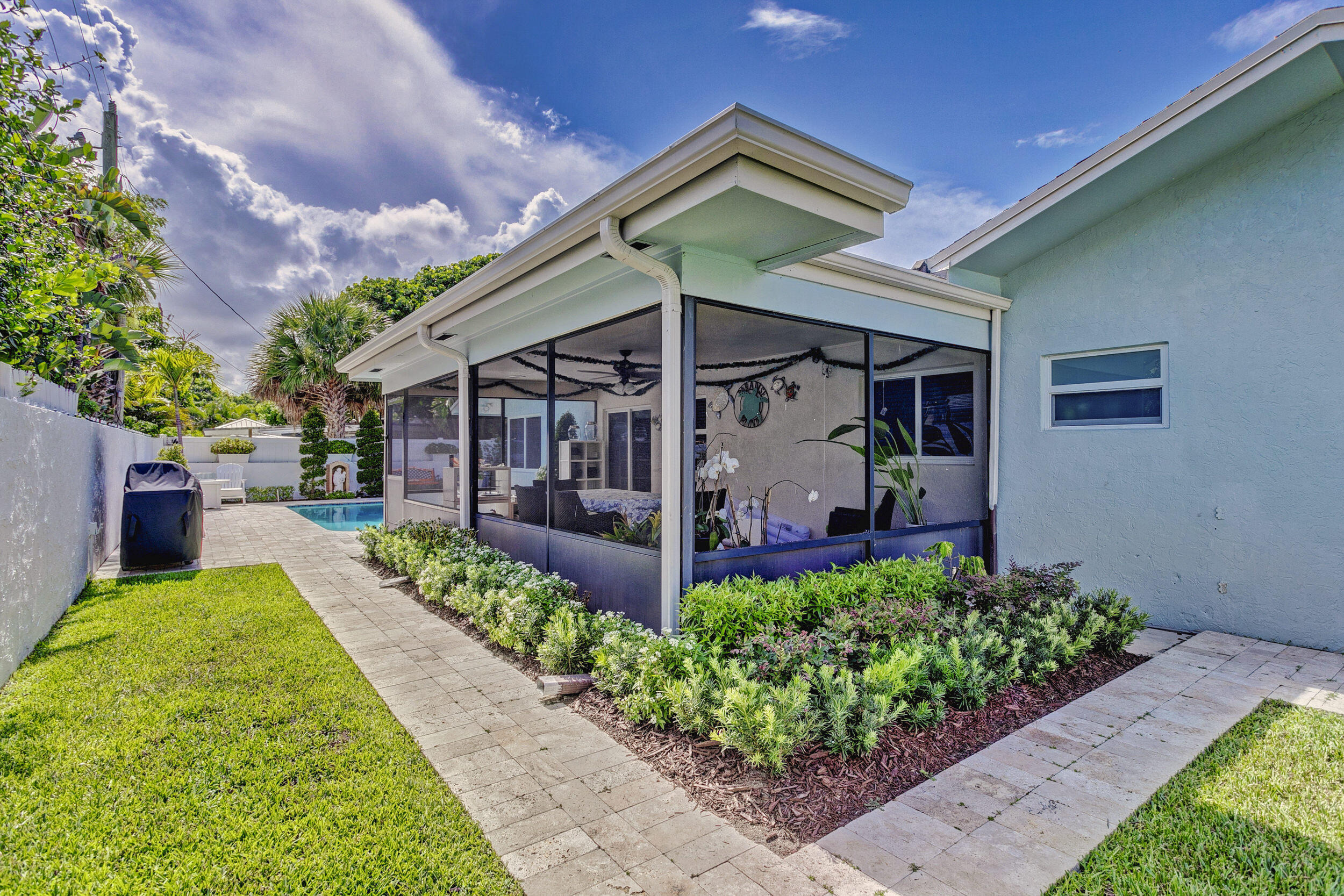 430 Mars Way Juno Beach, FL 33408 - Photo 48 of 65 a view of a house with potted plants and a yard