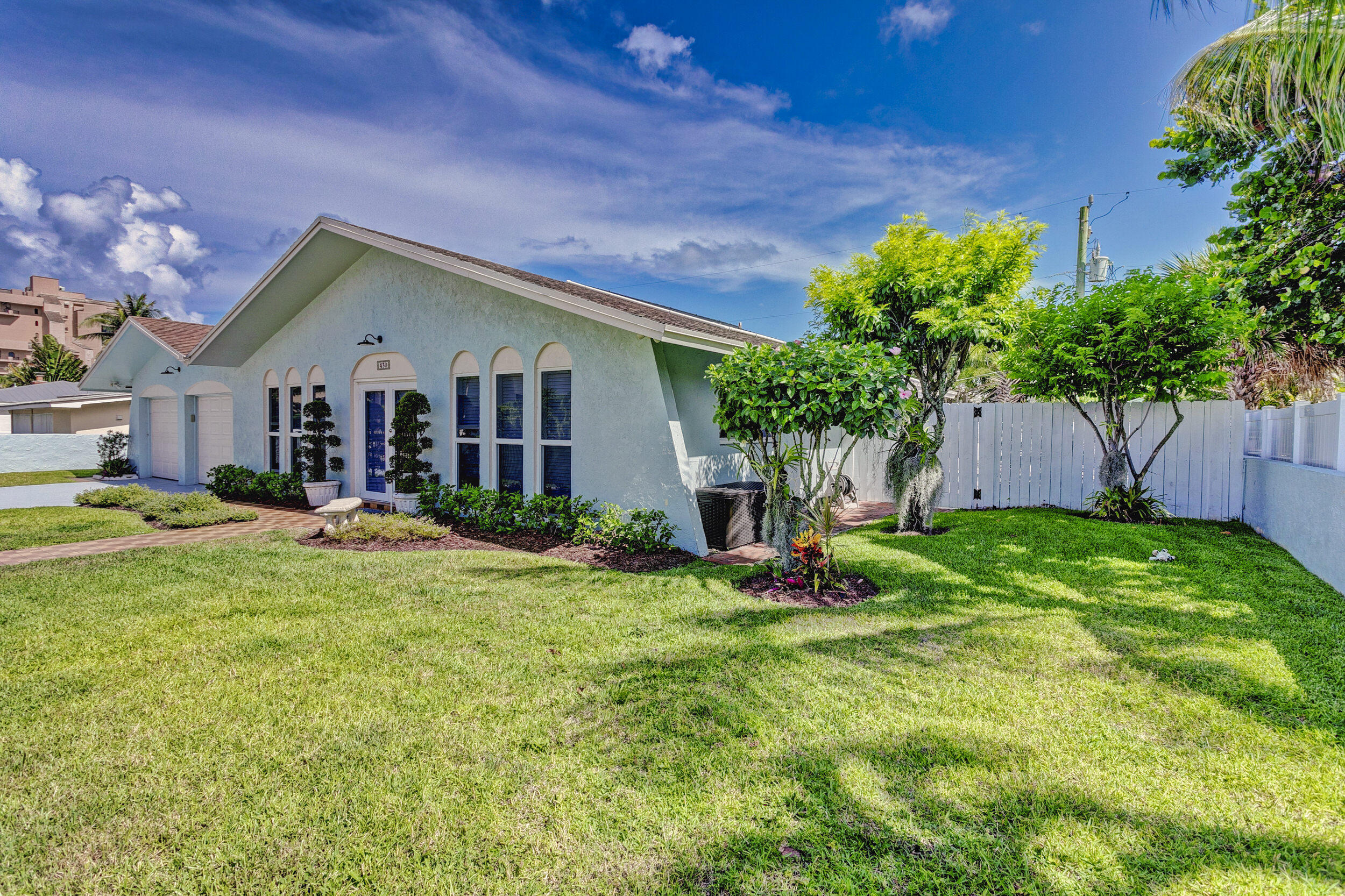 430 Mars Way Juno Beach, FL 33408 - Photo 6 of 65 a front view of house with yard and green space