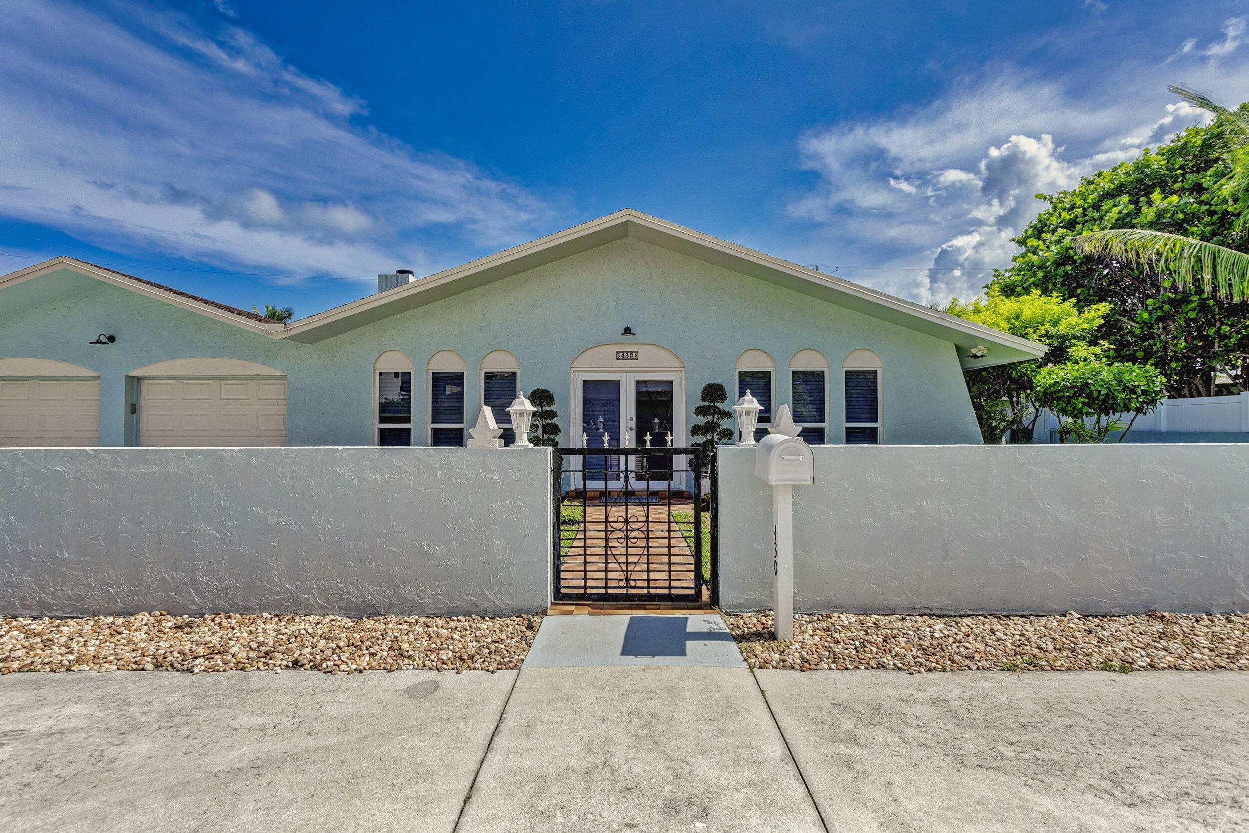 430 Mars Way Juno Beach, FL 33408 - Photo 8 of 65 front view of a house with a street