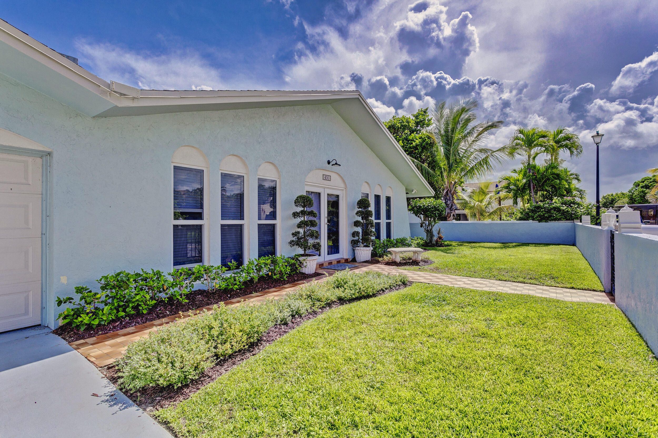 430 Mars Way Juno Beach, FL 33408 - Photo 9 of 65 a view of a house with swimming pool and a yard
