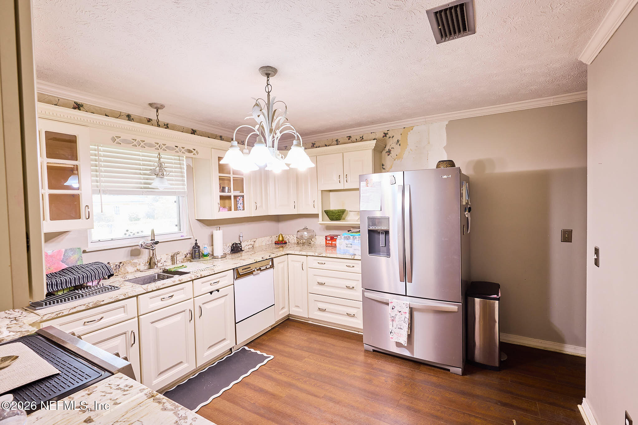 8965 San Rae Road Jacksonville, FL 32257 - Photo 26 of 46 a kitchen with a refrigerator a sink dishwasher and white cabinets with wooden floor
