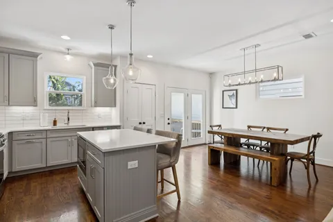 a kitchen with a table chairs stove and microwave