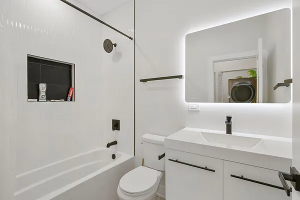 a bathroom with a sink toilet and shower