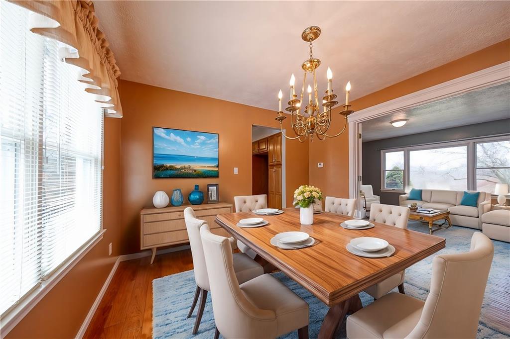 274 Evans Road Zelienople, PA 16063 - Photo 4 of 42 a view of a dining room with furniture wooden floor and chandelier