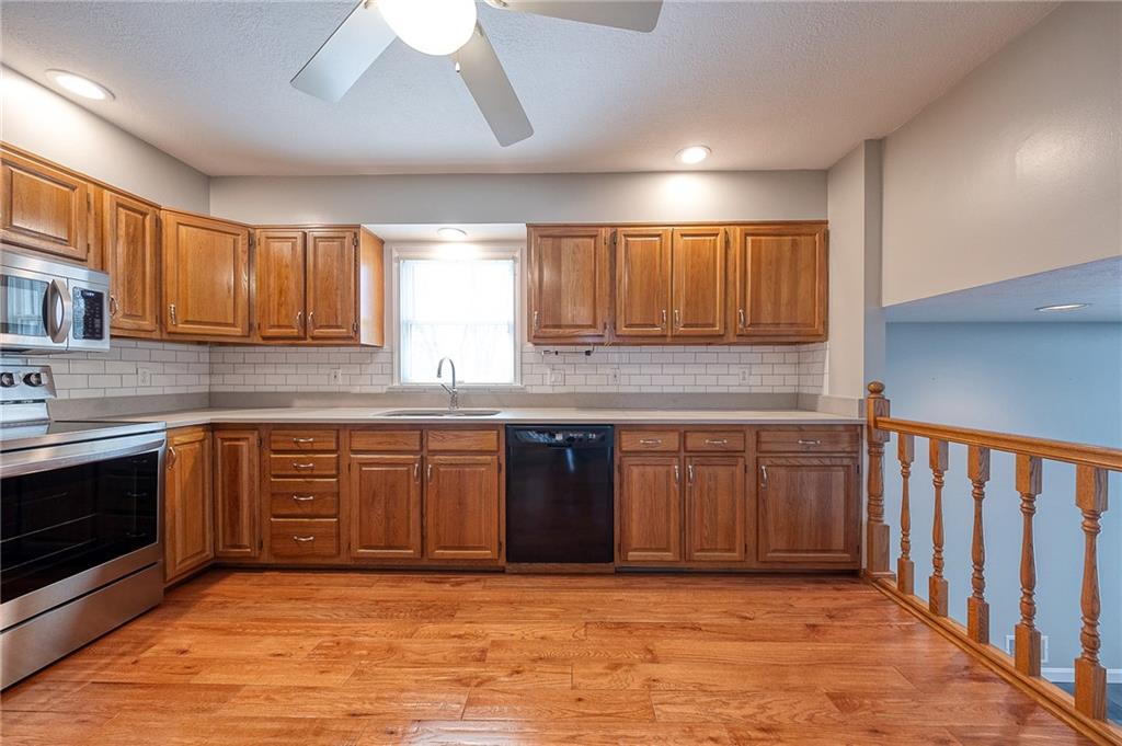 274 Evans Road Zelienople, PA 16063 - Photo 9 of 42 a kitchen with stainless steel appliances granite countertop a stove sink and cabinets