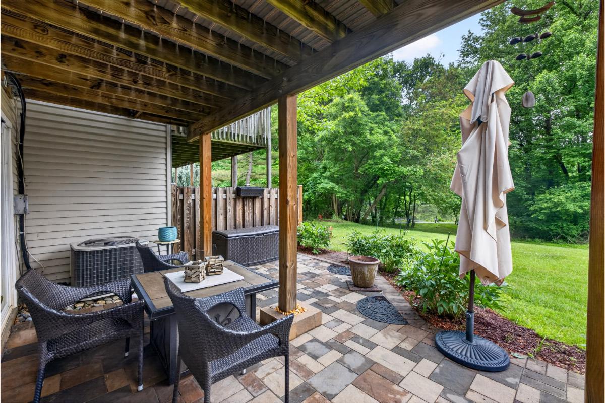 7347 Swan Point Way, Unit 122 Columbia, MD 21045 - Photo 38 of 54 a view of a patio with a table chairs and a backyard