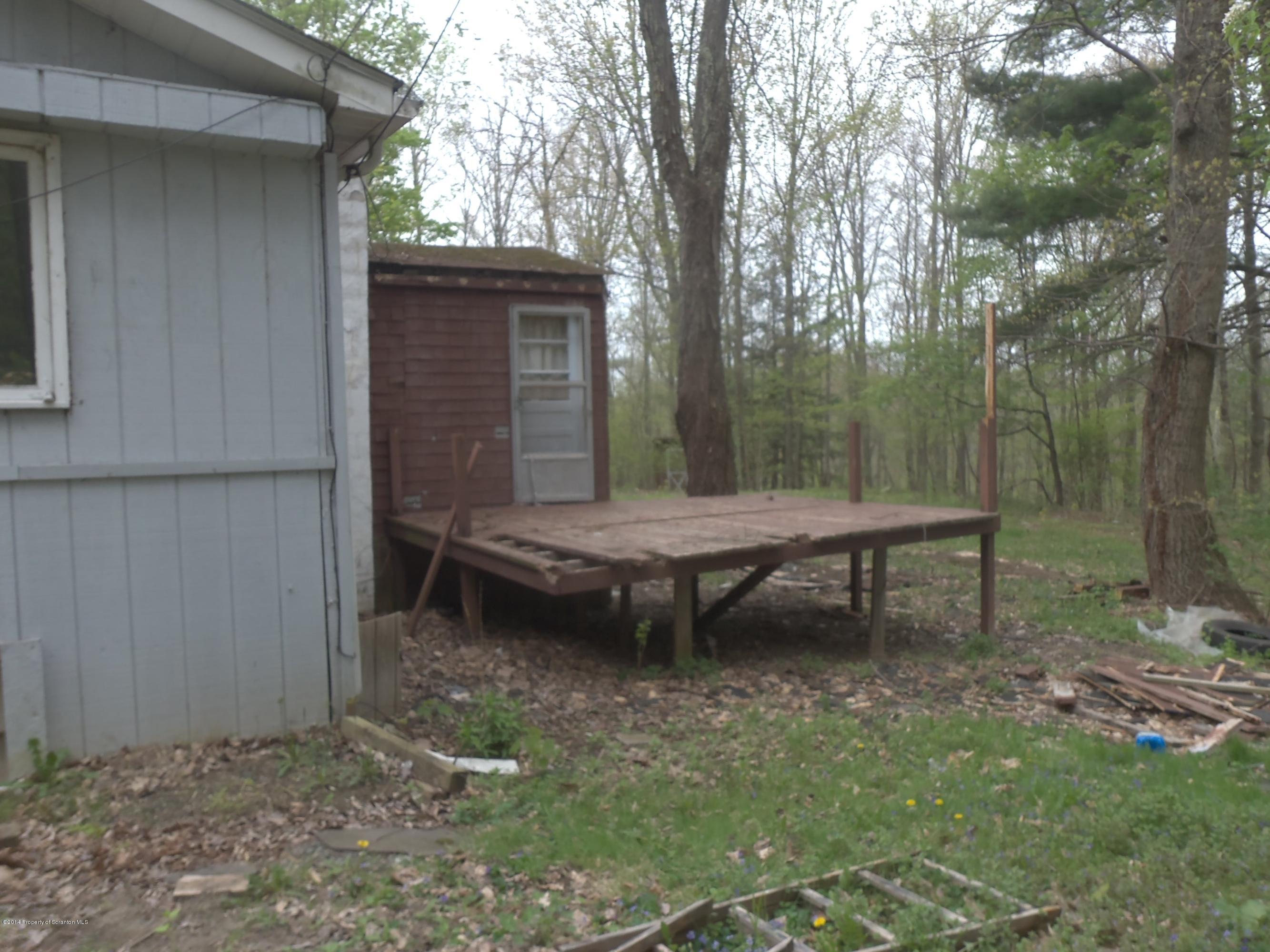 15 Padula Road Tunkhannock, PA 18657 - Photo 2 of 4 a backyard of a house with table and chairs