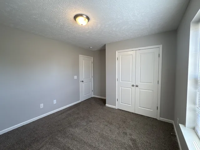 a view of an empty room and closet area