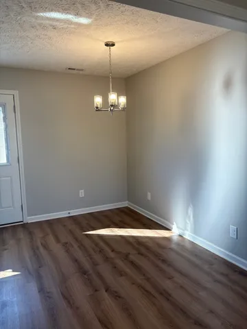 a view of room with wooden floor