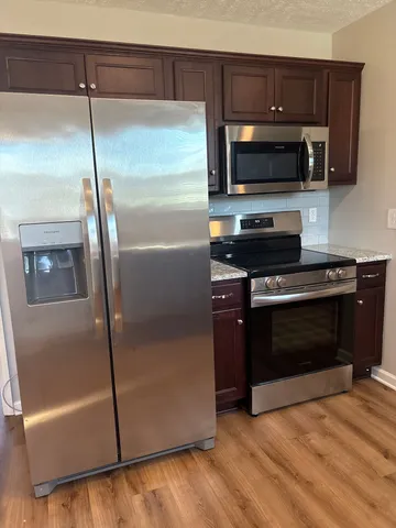a kitchen with a refrigerator and a microwave