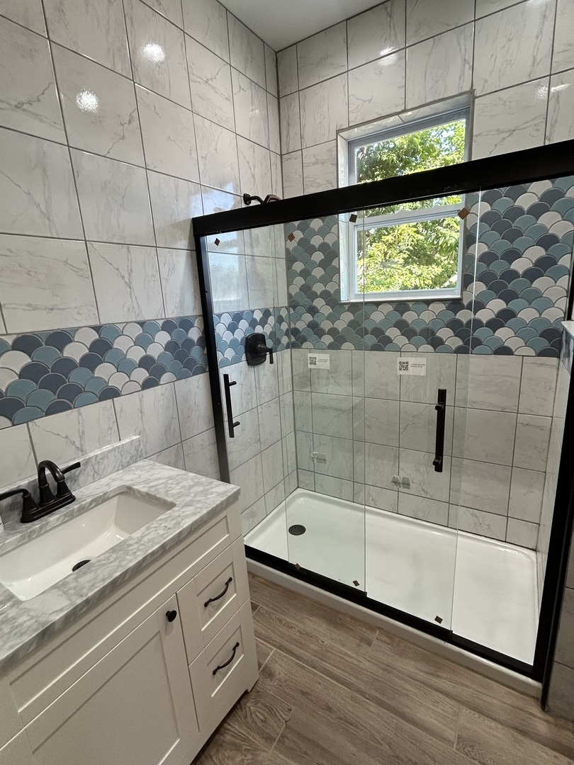200 East Dakota Street Spring Valley, IL 61362 - Photo 23 of 23 a bathroom with a granite countertop sink a mirror and shower