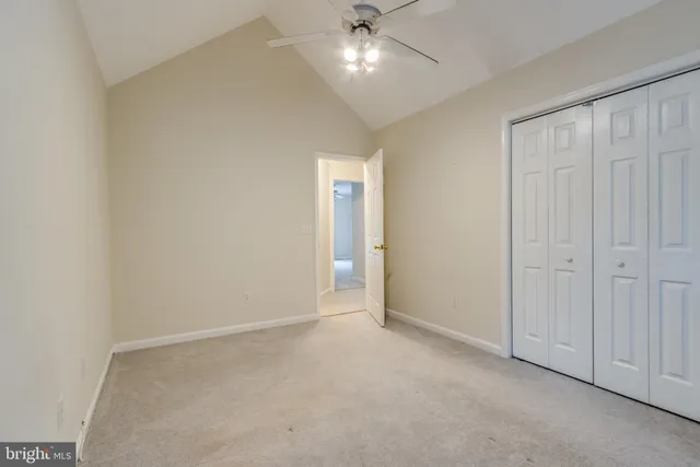 a view of an empty room and a ceiling fan
