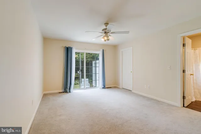 a view of a livingroom with a ceiling fan and window