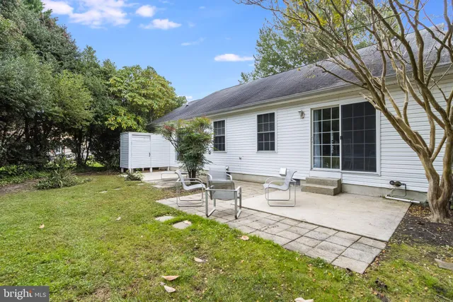 a view of a house with backyard and sitting area