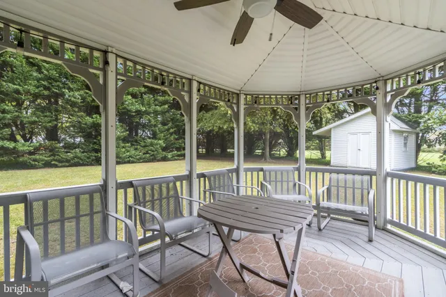 a view of a chair and table in the balcony