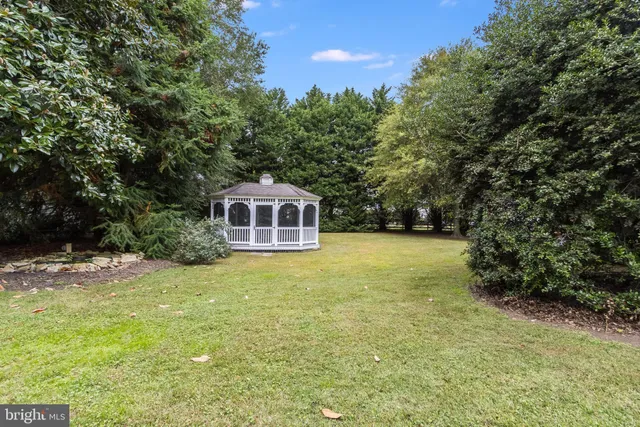 a yellow house with trees in front of it