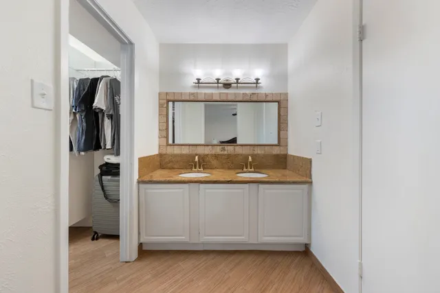 a view of bathroom with a sink and mirror
