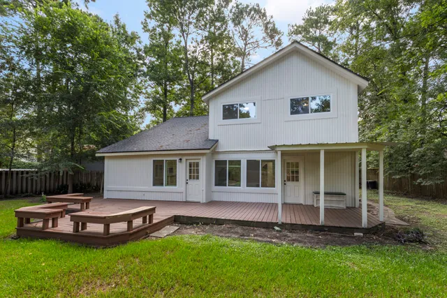 a view of a house with a yard and sitting area