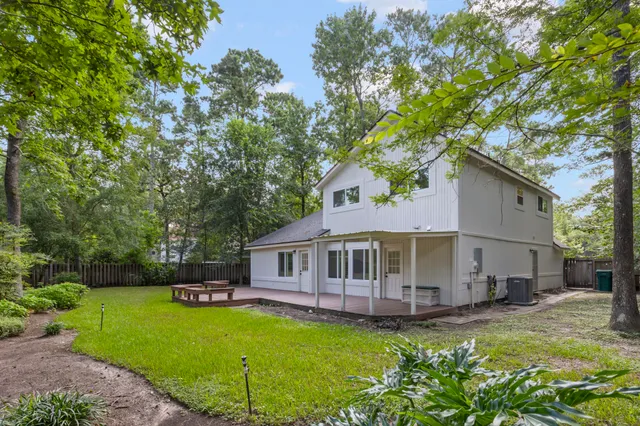 a view of a house with a swimming pool and a yard