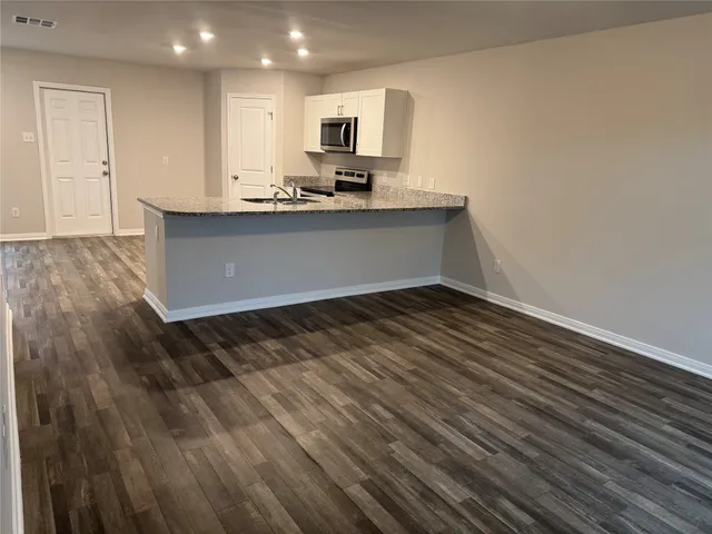a kitchen with a sink and cabinets