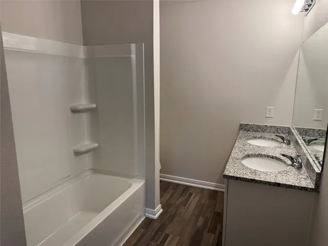 a bathroom with a tub sink and vanity