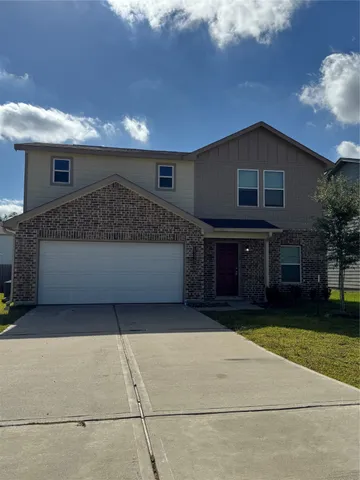a view of a house with a yard and a garage