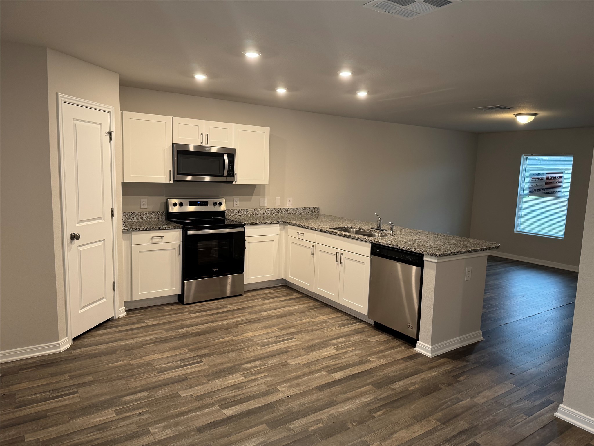 15520 Taylorcrest Drive Conroe, TX 77306 - Photo 7 of 24 a kitchen with stainless steel appliances a stove top oven and a refrigerator