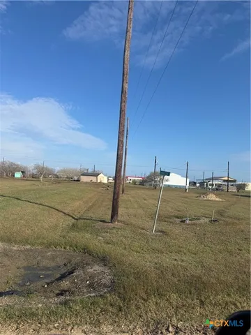 a view of a field with an ocean
