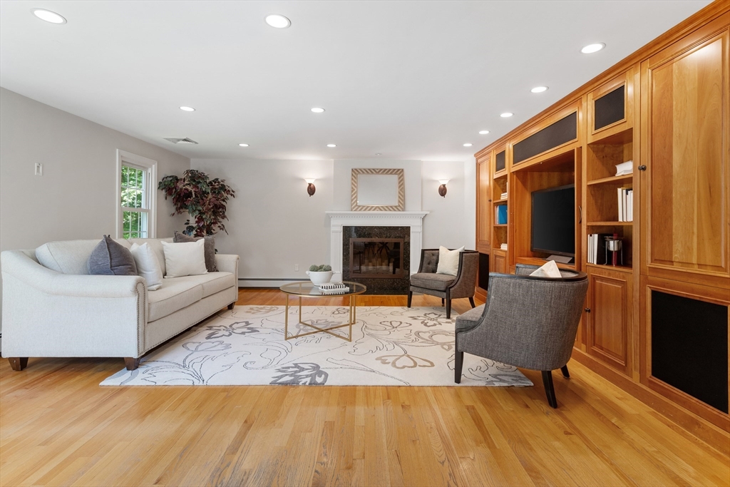 4 Bicentennial Drive Lexington, MA 02421 - Photo 17 of 35 a living room with furniture and a fireplace