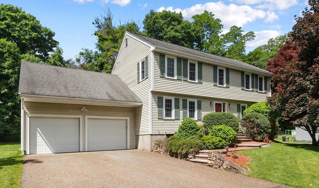 4 Bicentennial Drive Lexington, MA 02421 - Photo 2 of 35 a front view of a house with a garden