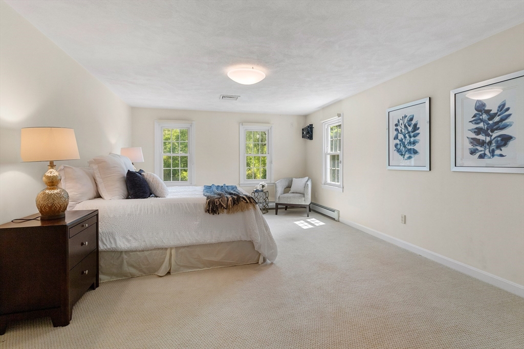 4 Bicentennial Drive Lexington, MA 02421 - Photo 21 of 35 a spacious bedroom with a bed and lamp