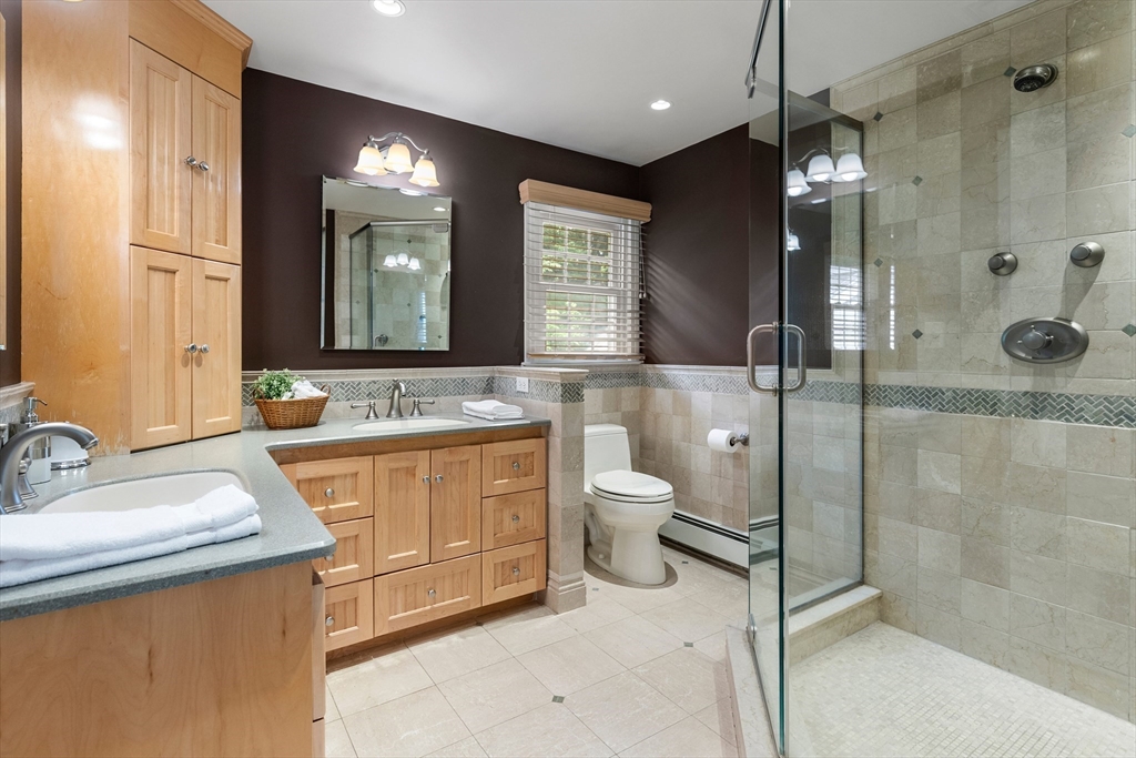4 Bicentennial Drive Lexington, MA 02421 - Photo 22 of 35 a bathroom with a double vanity sink toilet and shower