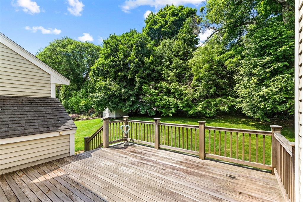 4 Bicentennial Drive Lexington, MA 02421 - Photo 5 of 35 a view of a deck with a large window and wooden fence
