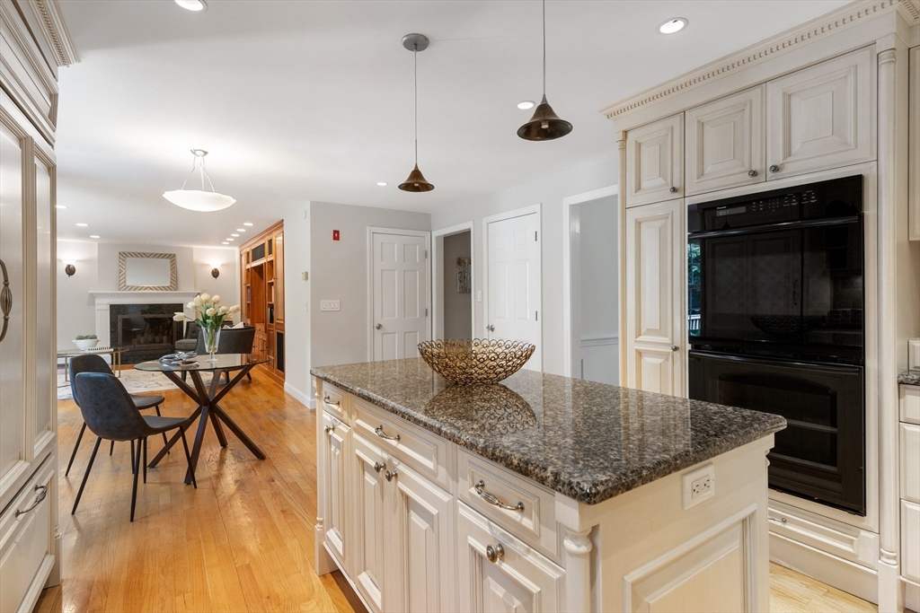 4 Bicentennial Drive Lexington, MA 02421 - Photo 9 of 35 a kitchen with stainless steel appliances granite countertop a stove top oven a refrigerator a sink and dishwasher