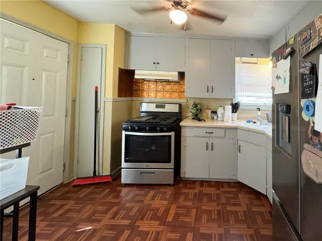 a kitchen with a stove a sink and a refrigerator