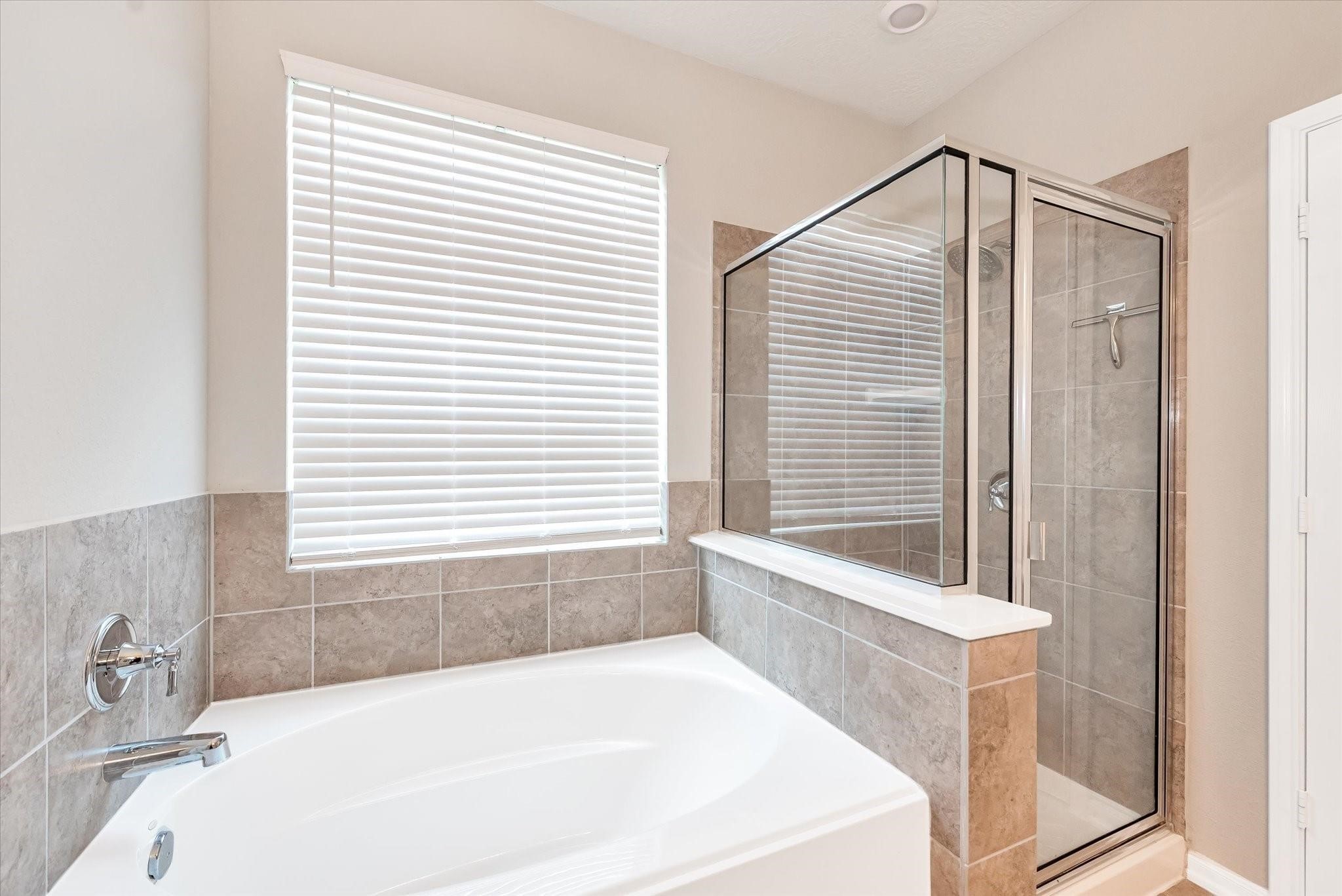 1111 Swinford Court Conroe, TX 77304 - Photo 11 of 21 a white bath tub sitting in a bathroom next to a window