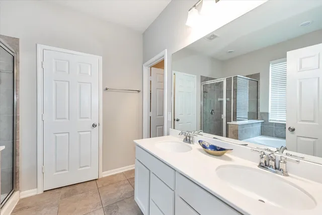 a white bath tub sitting in a bathroom next to a window