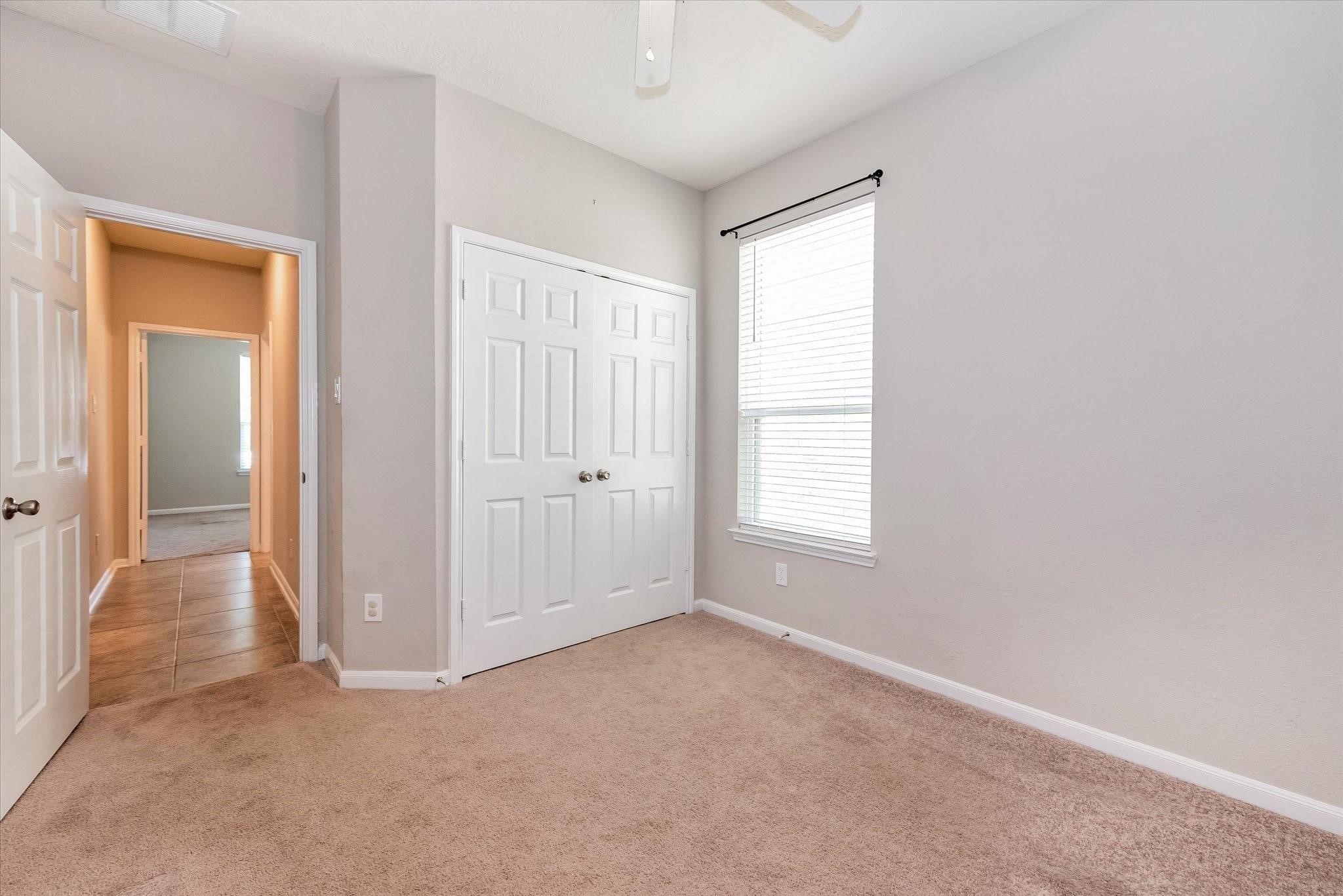 1111 Swinford Court Conroe, TX 77304 - Photo 13 of 21 a view of an empty room with closet and a window