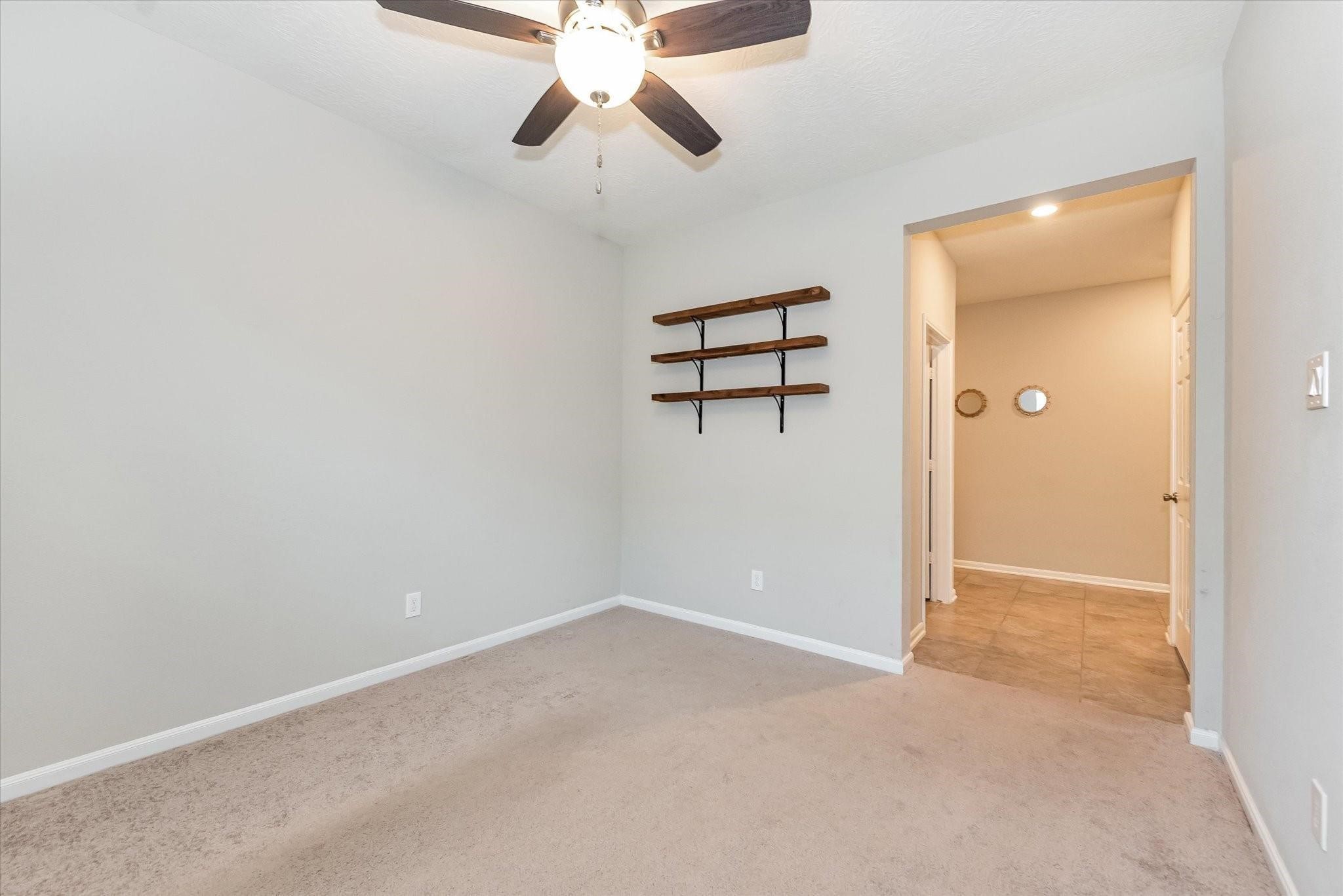 1111 Swinford Court Conroe, TX 77304 - Photo 17 of 21 an empty room with ceiling fan and window