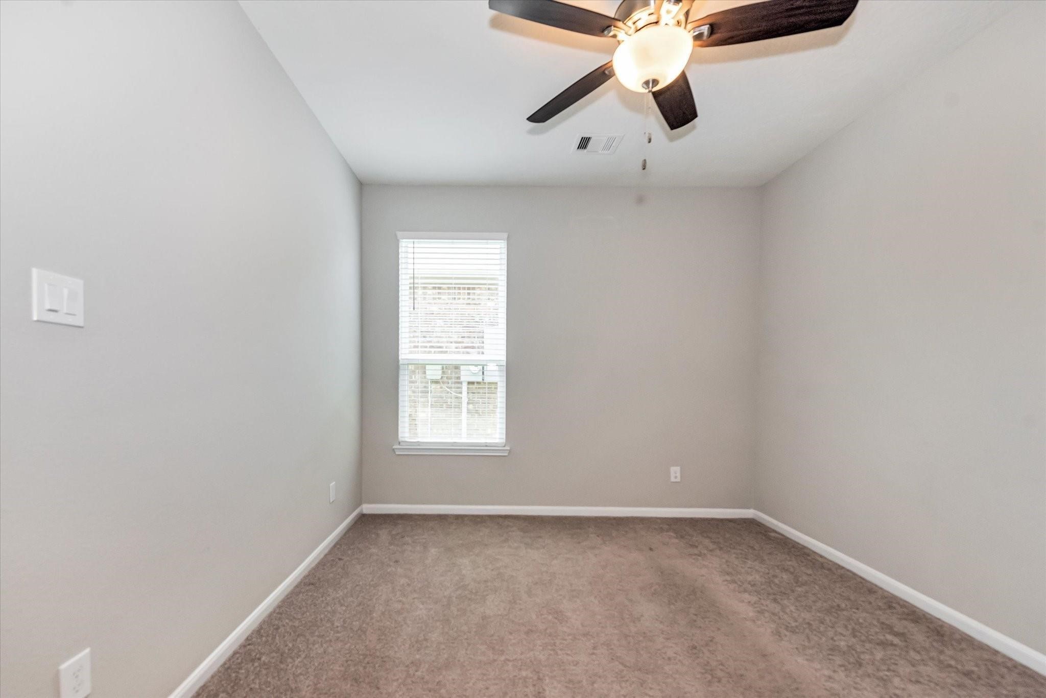 1111 Swinford Court Conroe, TX 77304 - Photo 18 of 21 an empty room with chandelier fan