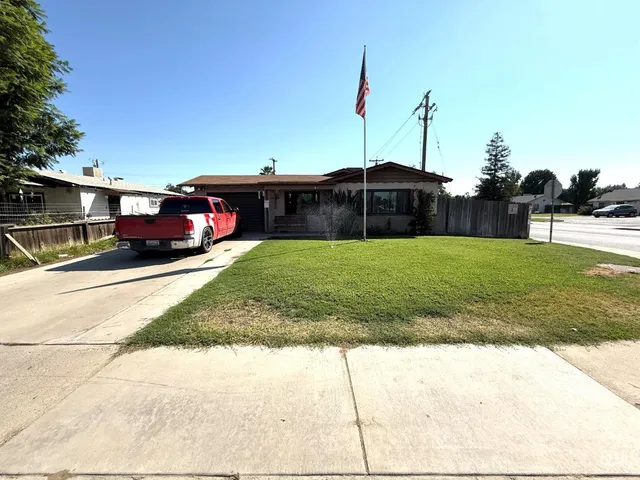 a view of a house with a yard and table